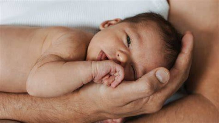 Why do dads hold newborns shirtless?