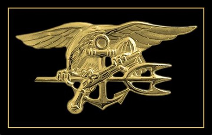 Why do SEALs pin Tridents on caskets?
